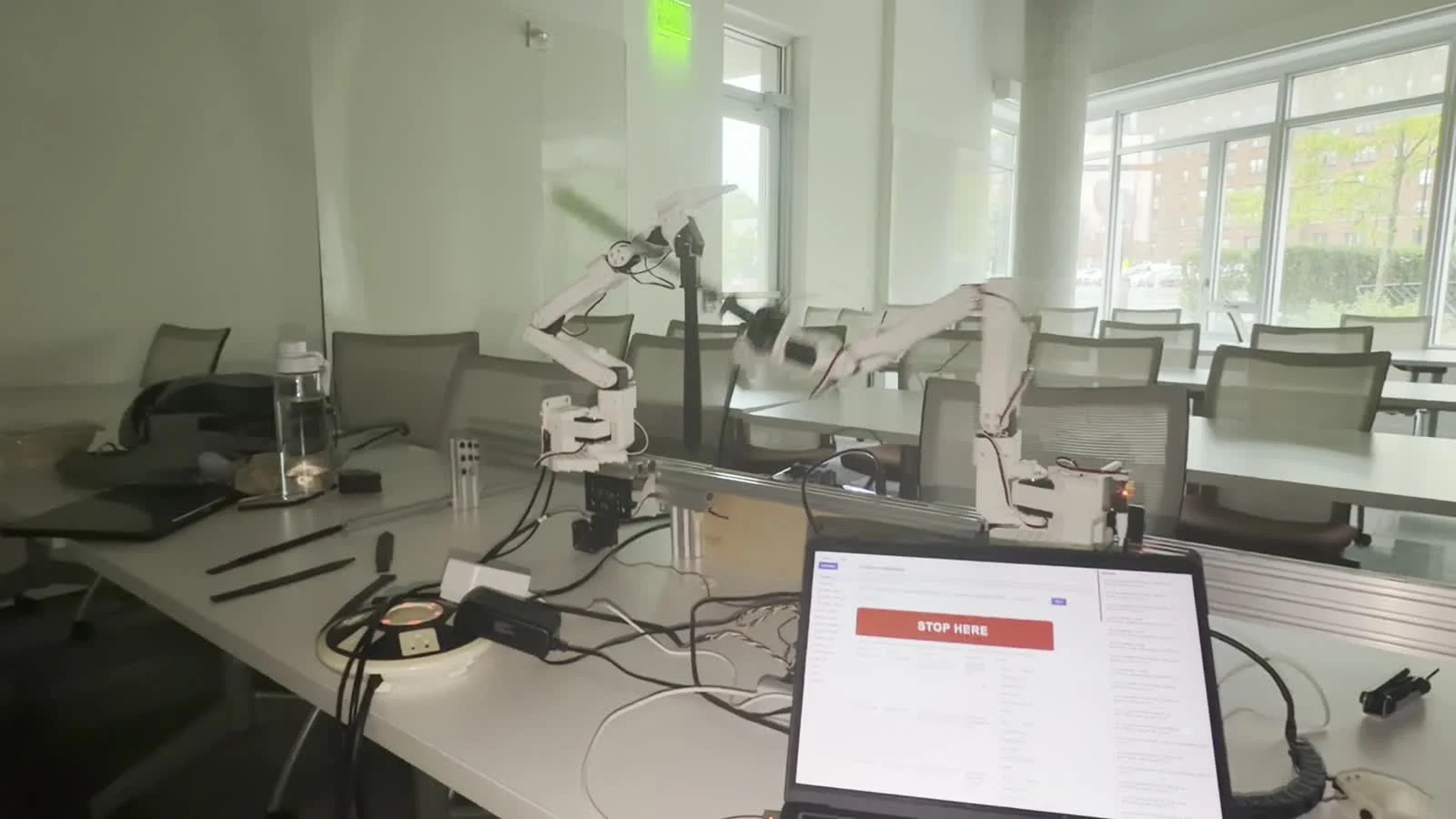 A hand holding the arm at a reference pose during calibration